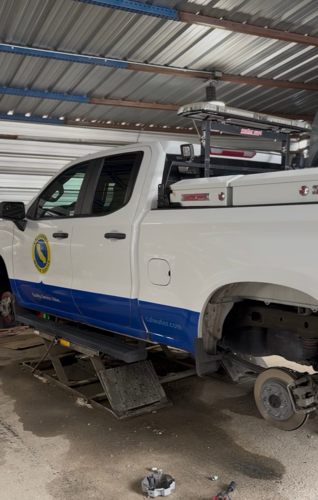 Fleet service truck raised for wheel and brake work at Trends